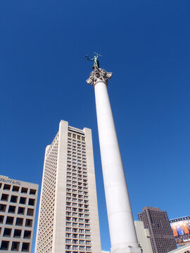 Union Square in San Francisco features a tall column with a statue under a clear blue sky during daytime
