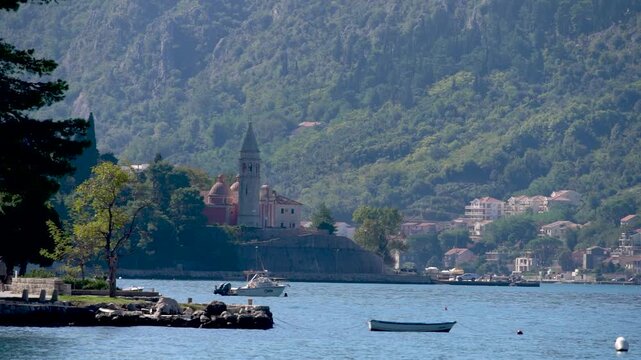 A sunny day and a church along the bay of Kotor in Montenegro. 