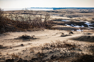 Winter landscape of sand dunes on the Curonian Spit near the frozen sea coast © Andrey Tishin