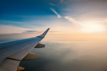 Obraz premium Aerial view from the plane over foggy clouds