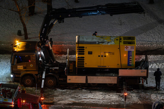 Kyiv, Ukraine &ndash; Jan 29, 2026: State Emergency Service of Ukraine personnel transfer industrial diesel generator for deployment after destruction of Darnytska CHP 4 plant in Darnytskyi district area.