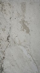Fototapeta premium A detailed, close-up photograph of a weathered gray concrete wall surface displaying rough, gritty, and aged imperfections and structure, rough, material, urban