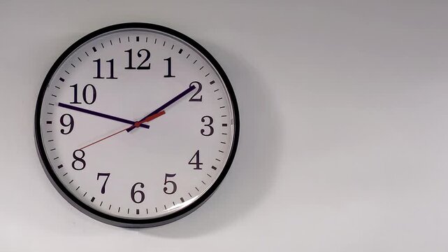 Analog wall clock spinning animation through the hours