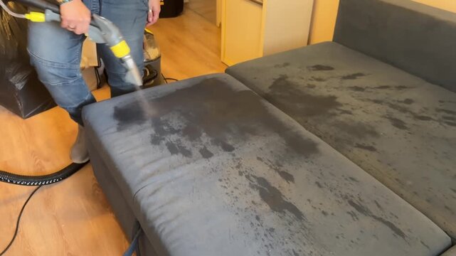 Cleaning a Couch with a Steam Cleaner in Action