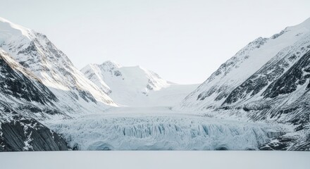 Obraz premium Glacier's textured face sits beneath snowy mountains, bright and icy scene