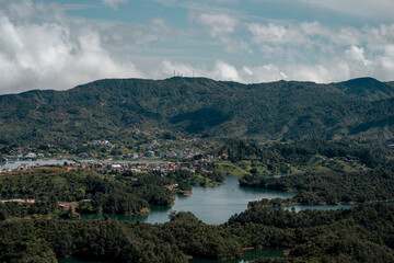 Fototapeta premium Guatapé reservoir landscape with town and lush mountains