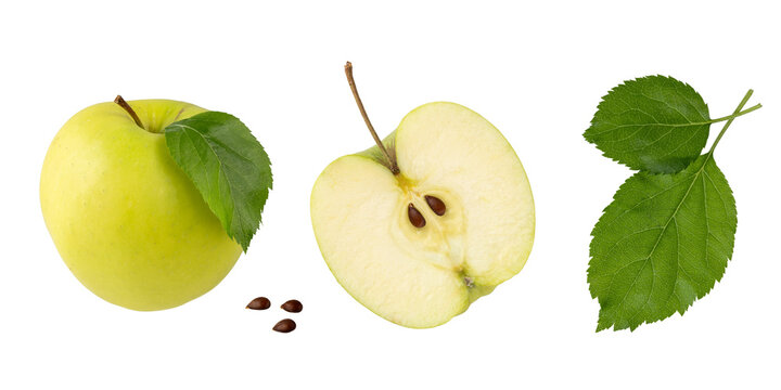 Green yellow apple Golden Delicious whole and half with leaves and seeds flying isolated on white. Fruits collection