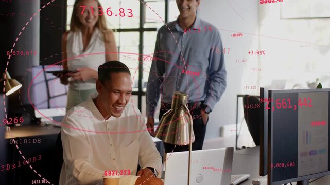 Seated man leaning into laptop, red graphs appearing on screen, team celebrating business win