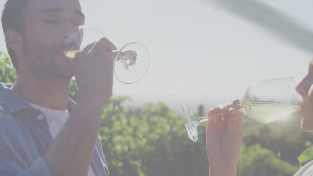 Couple standing in garden lifting glasses, tasting white wine, animated notes circling glasses
