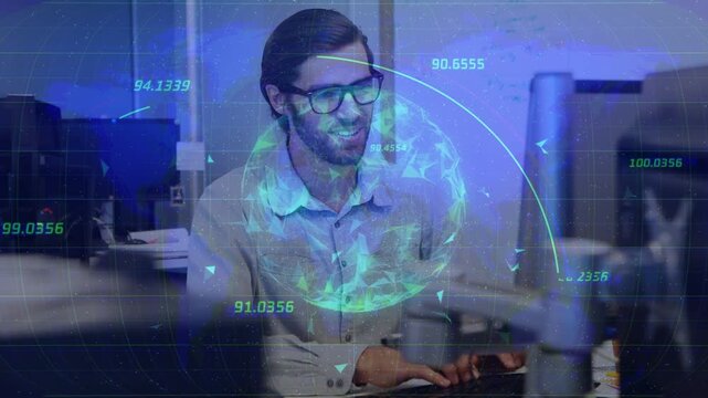 Vertical video: Typing man with glasses light shirt at office desk, reacting to holographic data