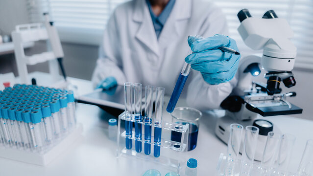 Scientist analyze biochemicals in a laboratory for health care research progress