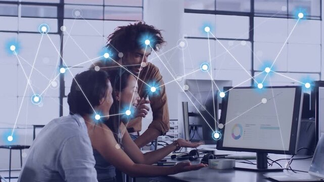 IT team leaning over screen center gesturing sparking network growing over pie or trend line analyzi