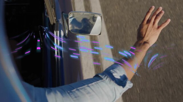 Man testing wind leaning arm out window, wrist rotating and purple-blue streaks tracing for ads