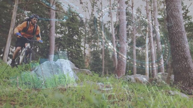 Male biker pedaling downhill, near ledge, popping over rock, clearing rock, sports HUD tracking
