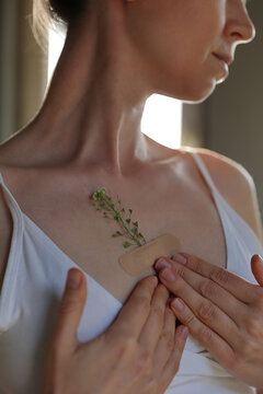 Broken Heart Healing Concept, Woman with Flower Bandage on Chest and Emotional Recovery Theme