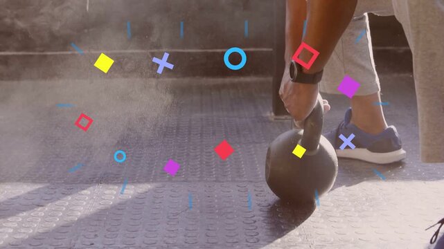 Mature man rubbing chalk and gripping kettlebell, driving hips and swinging for fitness training