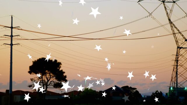 Camera panning right, revealing towers rising and white stars floating across dusk, showing grid