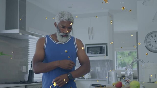 Man leaning, cutting apples in kitchen for snack, adjusting watch while gold stars overlay