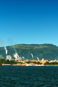 Canada, BC, Crofton.  Pulp and paper mill on the eastern shore of Vancouver Island.  The evidence of clear-cut logging visible on the distant hills.