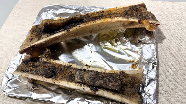 Roasted beef bone marrow culinary appetizer on foil