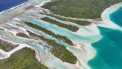 Fototapeta premium Aerial drone shot of turquoise lagoon in French Polynesia with tropical island, clear blue water and luxury travel destination
