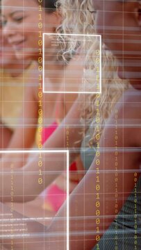 Vertical video: Camera widening and overlay showing, woman holding cup, women leaning, viewing tech