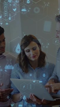 Vertical video: Team at laptop left man moving phone starting AR health icons woman reviewing data