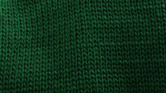 rotation of knitted green woolen textile fabric warm clothing