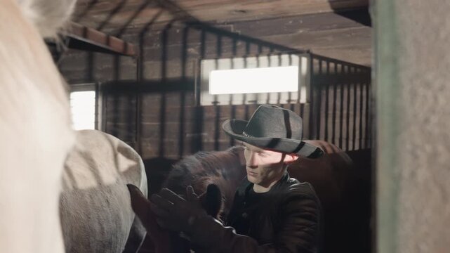Cowboy fitting saddle on horse back inside barn, detailed leather adjustment and girth check during handson tandem lesson, focused atmosphere with timber stalls and workshop light