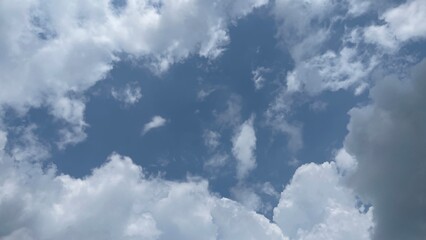 Obraz premium Clear Blue Sky with Soft White Cumulus Clouds Bright Daylight Atmosphere and Open Space Background for Nature Calm Weather and Minimal Sky Scene