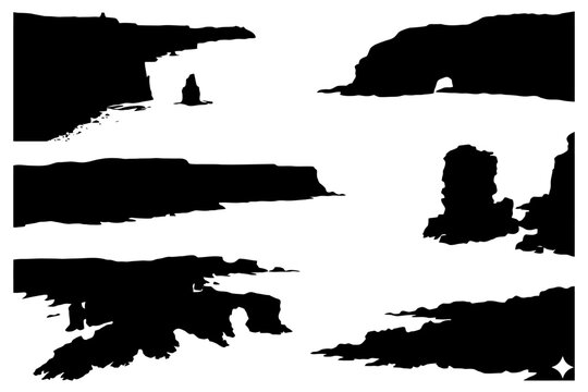 Dramatic coastal cliffs and rock formations silhouettes under white sky.