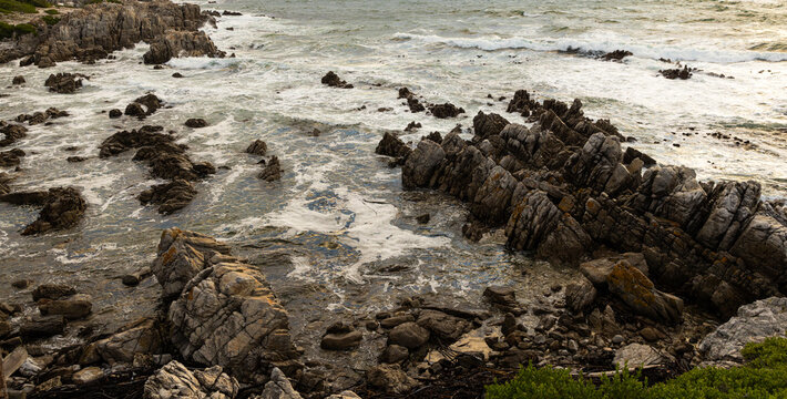 stormy waves crashing over rocky coastline, DeKelders, South Africa