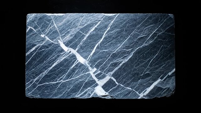 Dark marble slab with white veins on black background