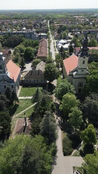 Cinematic vertical perspective of religious architecture in town center of Vrbas during sunny day, northern Serbia.