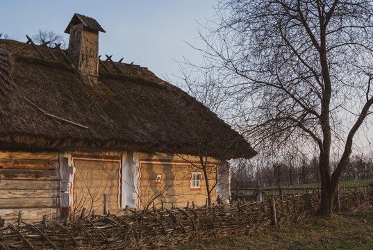 Sunlit folk ornament &ndash; decorative border on a thatched Ukrainian homestead 