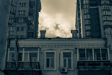 Dramatic cloudy sky framed by contrasting generations of city housing  © Дмитро Ганжеєв