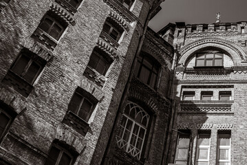 Dramatic monochrome facade with decorative corbelled arch and patterned cornice © Дмитро Ганжеєв