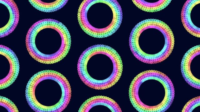 Abstract geometric footage of repeating rainbow circle rings made of dots on a dark blue background, colorful looping pattern for backgrounds, ads, and motion design
