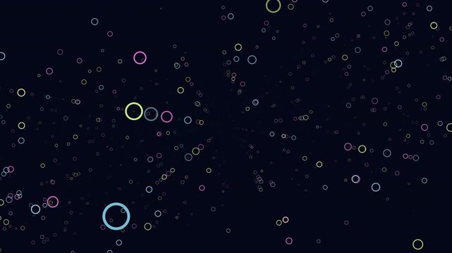 Footage of multicolored neon ring particles drifting and twinkling on a deep dark background, creating an abstract bokeh pattern for overlays, intros, and titles