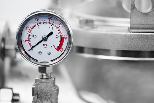 Industrial  concept. equipment of boiler-house, - valves, tubes, pressure gauges, thermometer. Close up of manometer, pipe, flow meter, water pumps and valves of heating system in  boiler room.