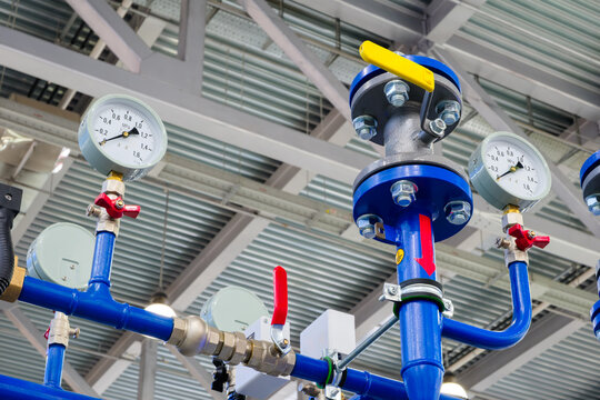 Industrial  concept. equipment of boiler-house, - valves, tubes, pressure gauges, thermometer. Close up of manometer, pipe, flow meter, water pumps and valves of heating system in  boiler room.