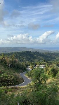 Winding road down through east coast forest and countryside on the east coast of Barbados. Ideal b roll background clip for travel and lifestyle content.