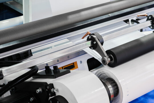 Industrial printer for printing on polyethylene film for packaging various products, industrial concept background.