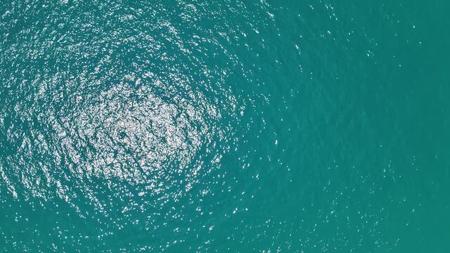 Aerial View of Turquoise Sea Sunlight Reflections on Water Surface Creating Mesmerizing and Tranquil Ocean Patterns