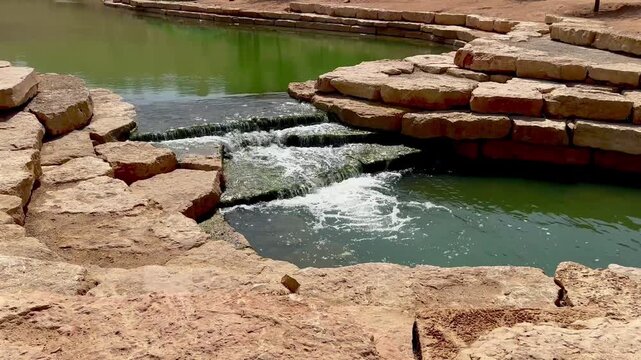 Crystal Clear Water Flowing Over Stone Steps in Wadi Hanifa