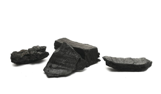 Black charcoal pile isolated on white background, side view, design element