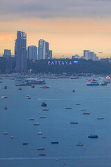 Obraz premium Pattaya cityscape with numerous boats in the bay at dusk