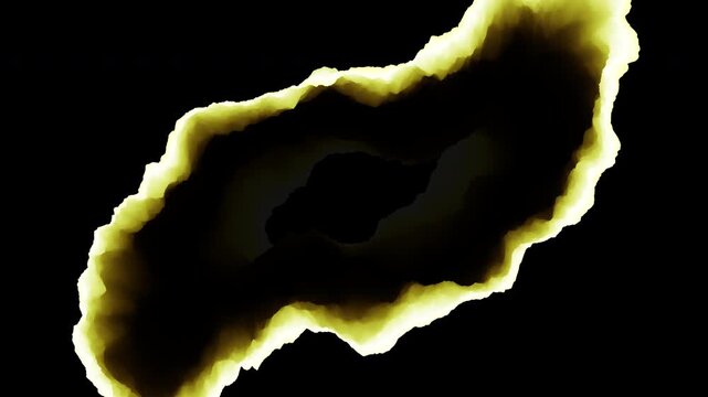 Abstract close-up footage of a burnt paper hole with glowing yellow edges and dark char, isolated on black background for fire, damage, decay, or transition concepts