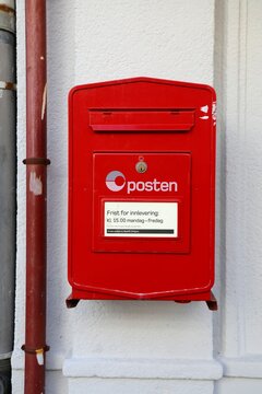 BERGEN, NORWAY - JULY 23, 2020: Red post box of Posten Norge (The Norwegian Post) in Bergen. Posten was founded in 1647.