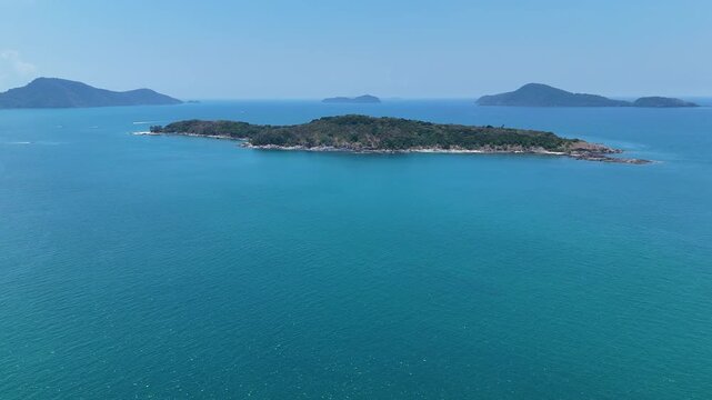Aerial View of Serene Island Surrounded by Clear Blue Sea and Sky, Evoking Tranquility and Escape in Nature